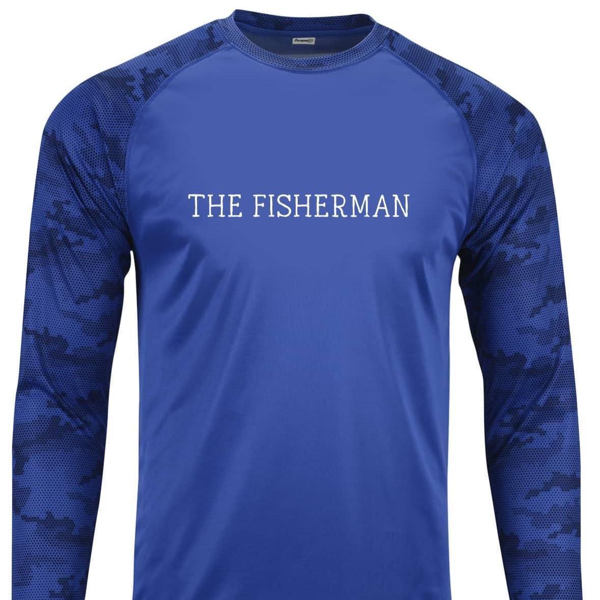 May include: A royal blue long-sleeved shirt with a white camouflage pattern on the sleeves. The shirt has a white crew neck and the words 'THE FISHERMAN' printed in white on the front.