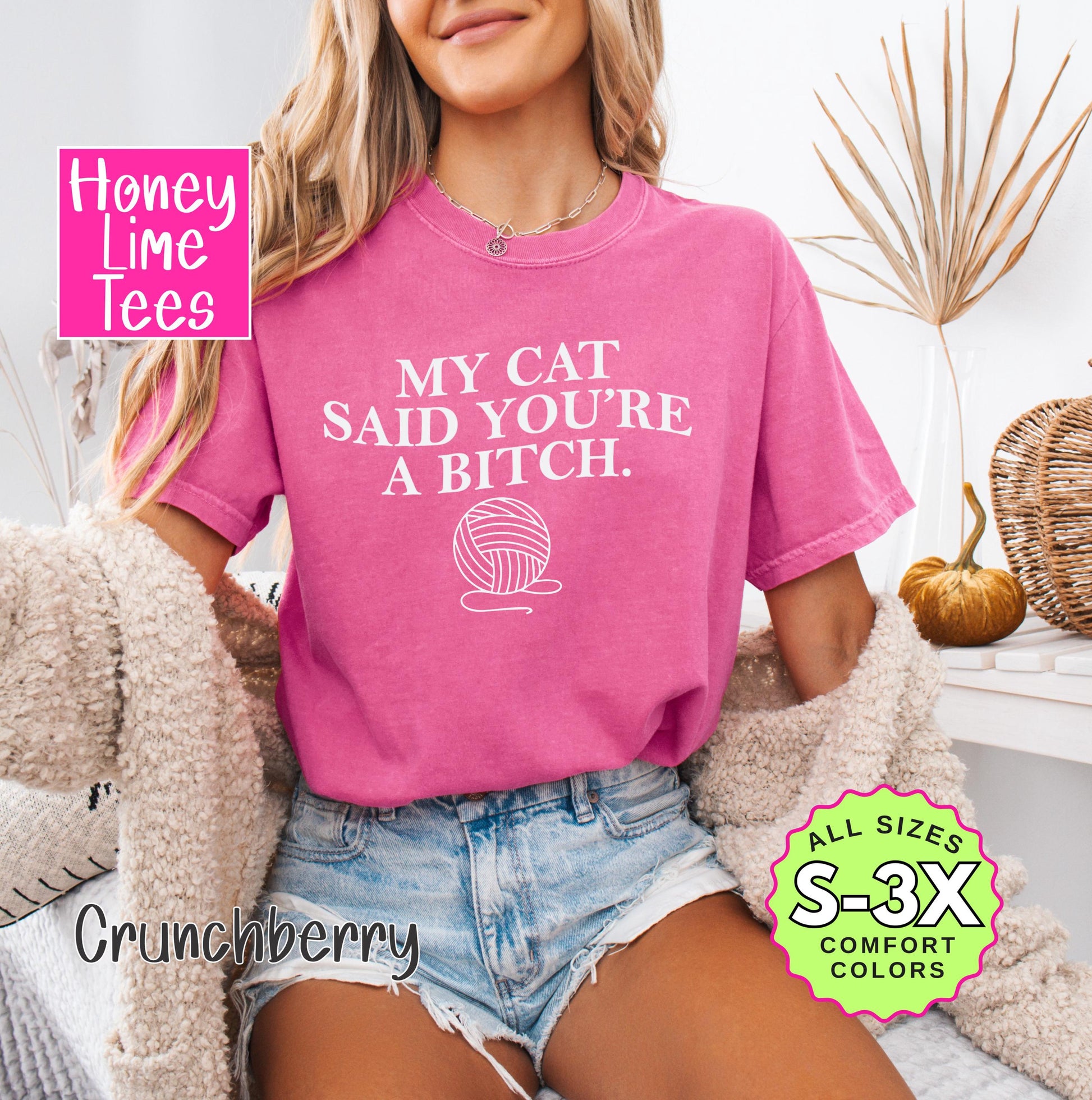a woman wearing a pink shirt that says my cat said you're a bitch