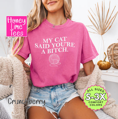 a woman wearing a pink shirt that says my cat said you're a bitch