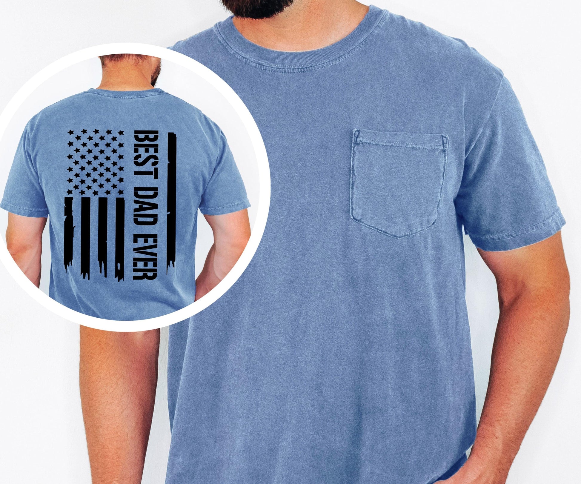 May include: A blue short-sleeved t-shirt with a chest pocket. The back of the shirt features a black graphic of the American flag with the text "BEST DAD EVER" printed vertically on the right side.
