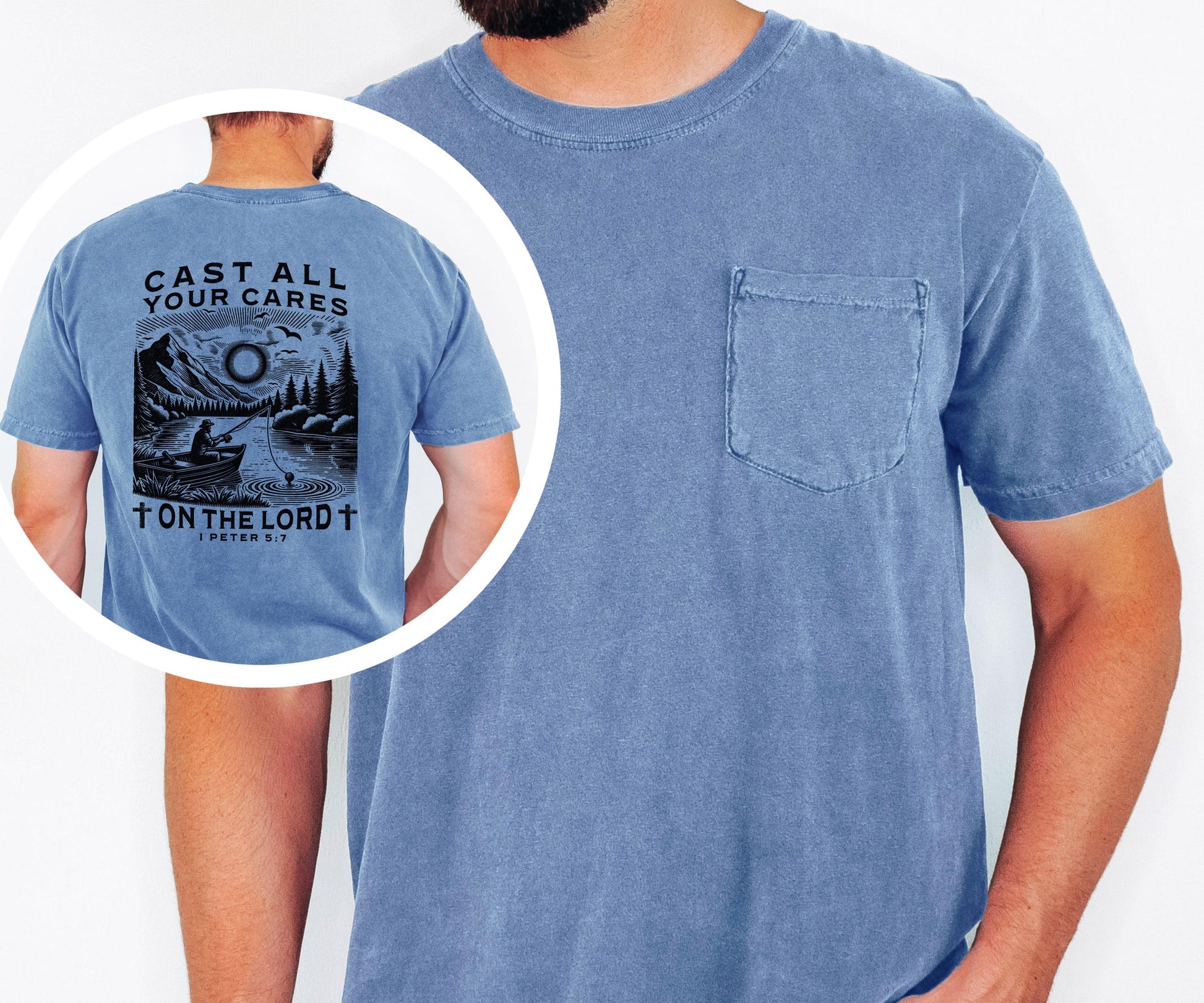 May include: A blue short-sleeved t-shirt with a pocket on the chest. The back of the shirt features a black and white graphic of a person fishing on a lake, with the text "CAST ALL YOUR CARES ON THE LORD" and a Bible verse reference.