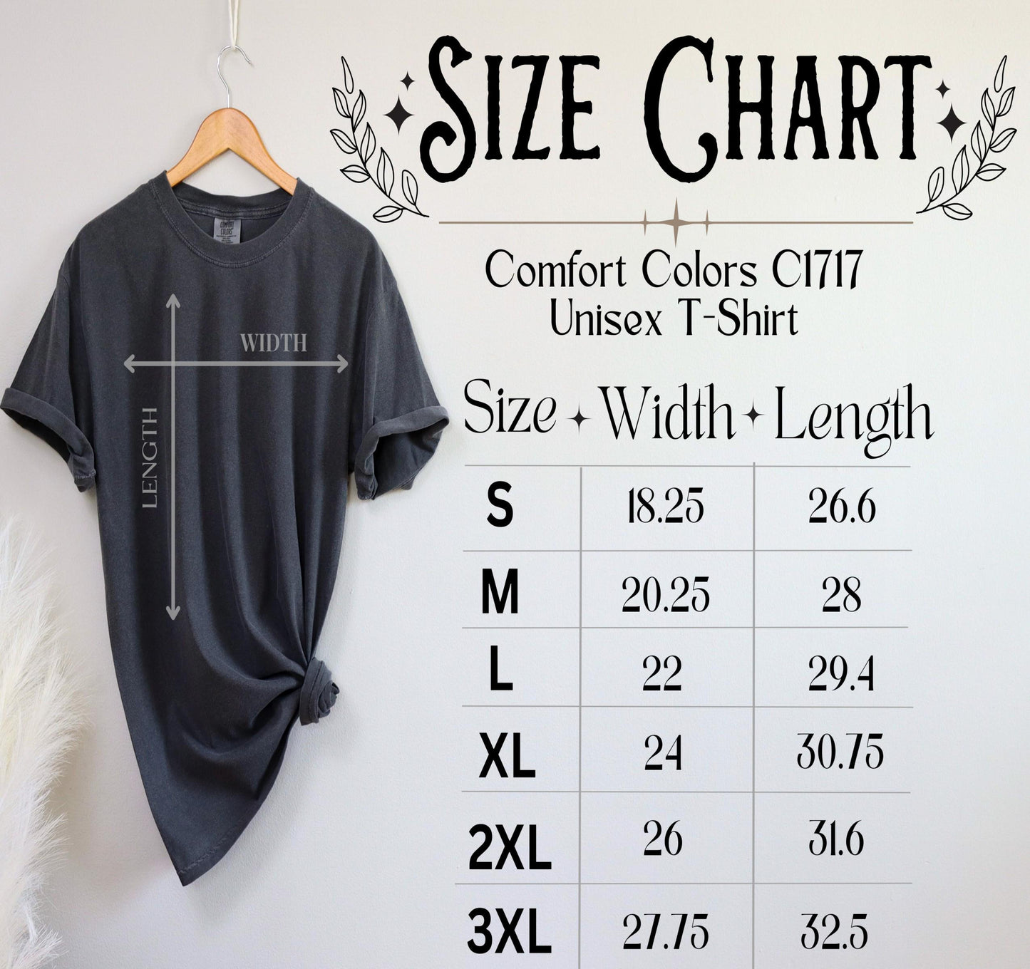 a black t-shirt hanging on a wooden hanger, with a size chart below it providing measurements for different sizes.